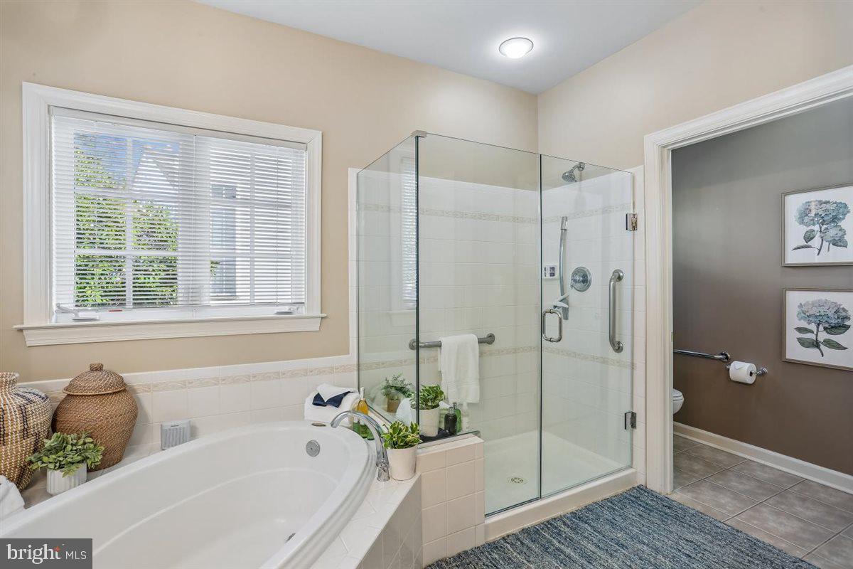 3738 Gleneagles Drive Silver Spring, MD 20906 - Photo 31 of 71 a bathroom with a tub shower and window