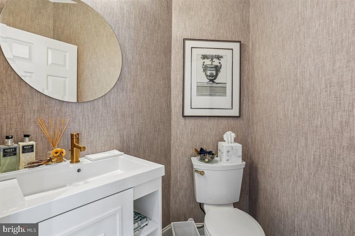 3738 Gleneagles Drive Silver Spring, MD 20906 - Photo 34 of 71 a bathroom with a sink mirror and toilet