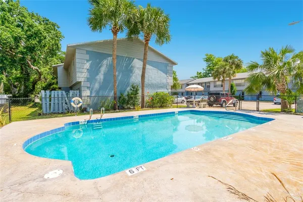 a view of a swimming pool with a lounge chair