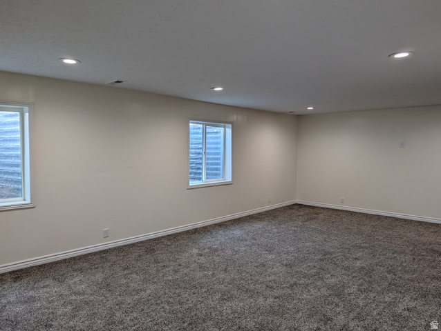 171 South Mustang Road East Grantsville, UT 84029 - Photo 28 of 41 Spacious room featuring neutral paint, recessed lighting, two windows, wall-to-wall carpeting, and white baseboards