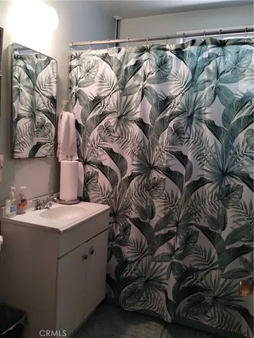 a bedroom with two beds and a painting on the wall