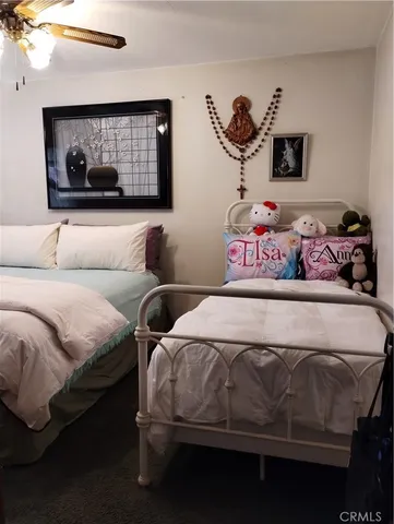 a living room with furniture a flat screen tv and a floor to ceiling window