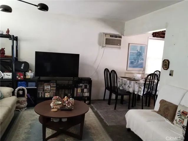 a view of a dining room with furniture and a window