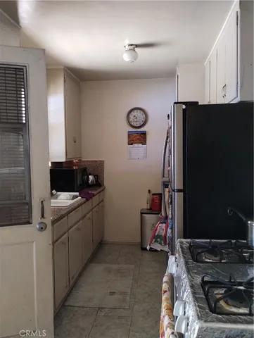 a backyard of a house with potted plants and brick wall