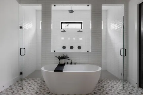 a bathroom with a bathtub and shower