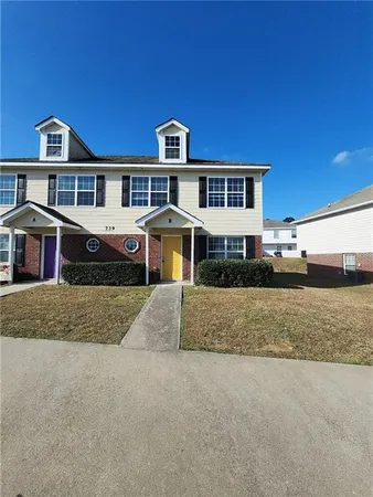 a front view of a house with a yard