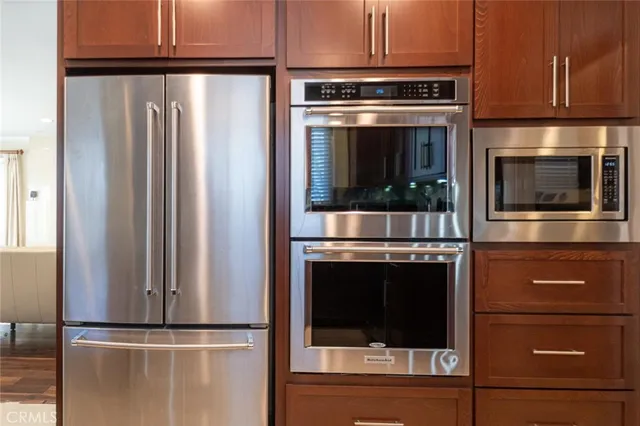 a kitchen with granite countertop stainless steel appliances and cabinets