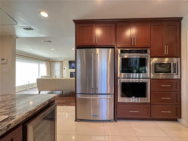 a kitchen with a refrigerator and a sink