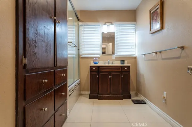 a room with granite countertop cabinets and black appliances