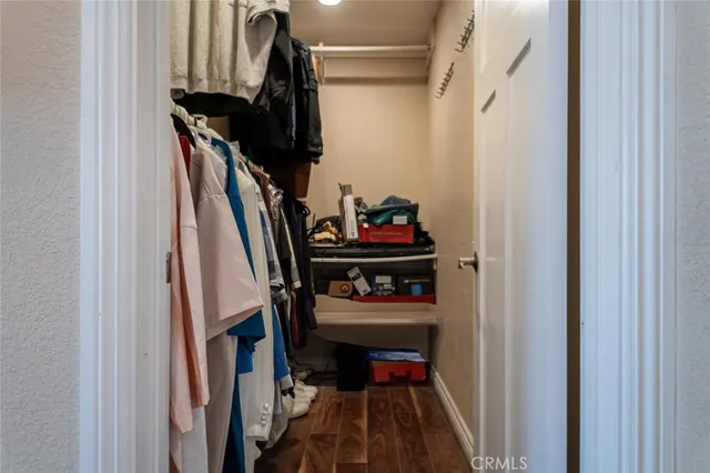 a view of walk in closet with clothes and shoes