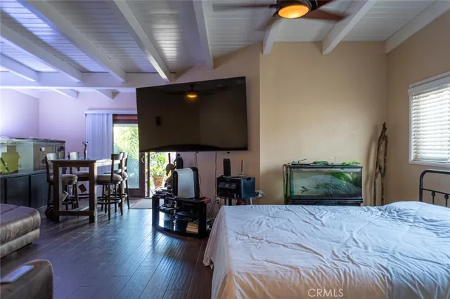a bedroom with furniture and a flat screen tv