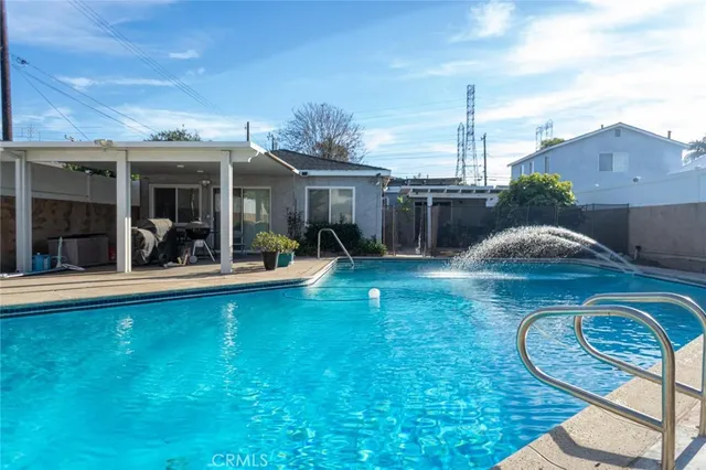 a view of a house with backyard porch and sitting area