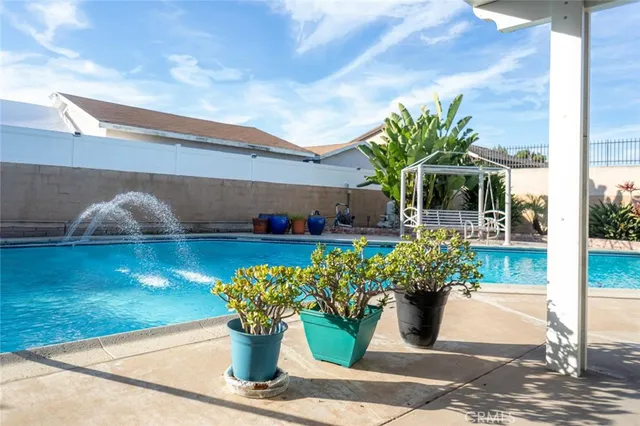 a white vase with white and yellow flowers