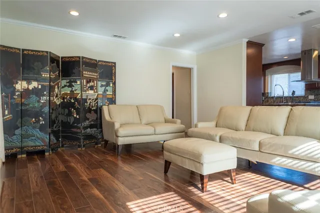 a living room with furniture a ceiling fan and a rug