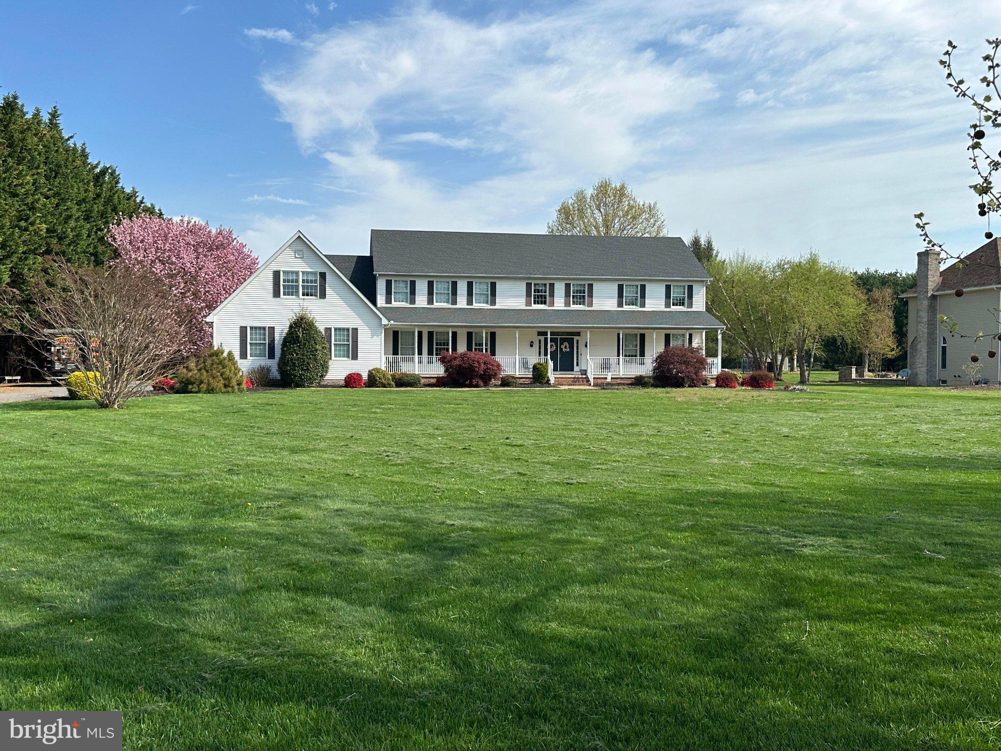 Charming home on lush green grounds.