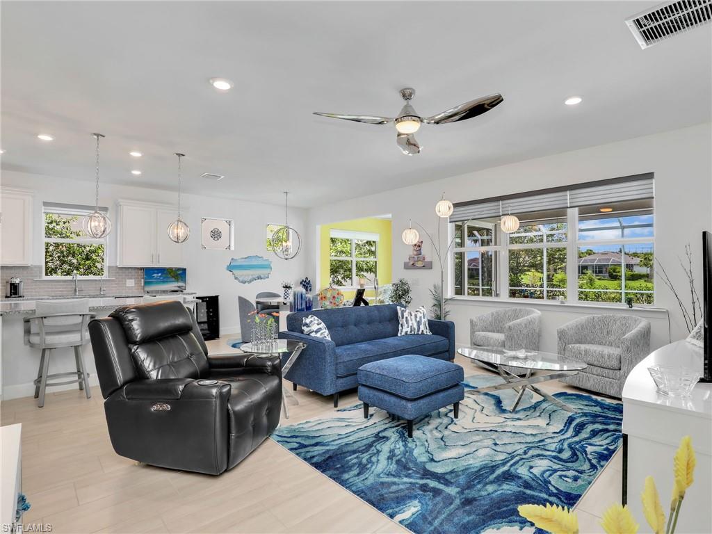 20064 Wymberly Way Estero, FL 33928 - Photo 13 of 47 a living room with fireplace furniture and a large window