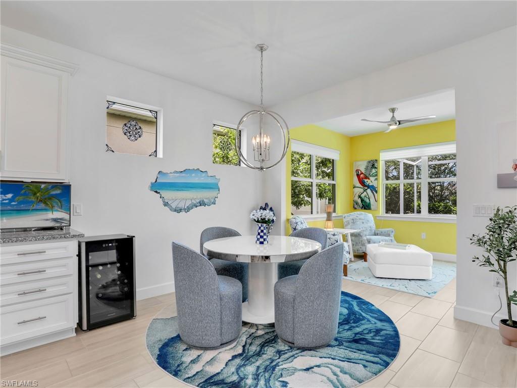 20064 Wymberly Way Estero, FL 33928 - Photo 17 of 47 a dining room with furniture a chandelier and window