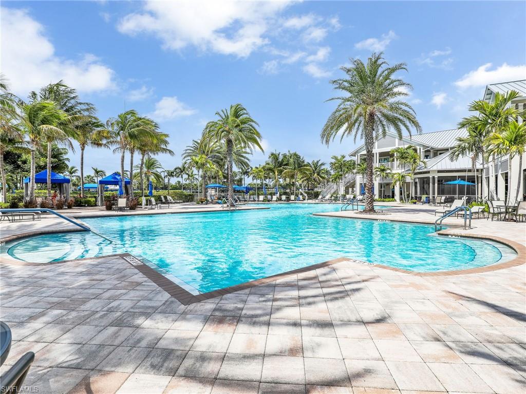 20064 Wymberly Way Estero, FL 33928 - Photo 33 of 47 a view of a swimming pool with a yard and palm trees
