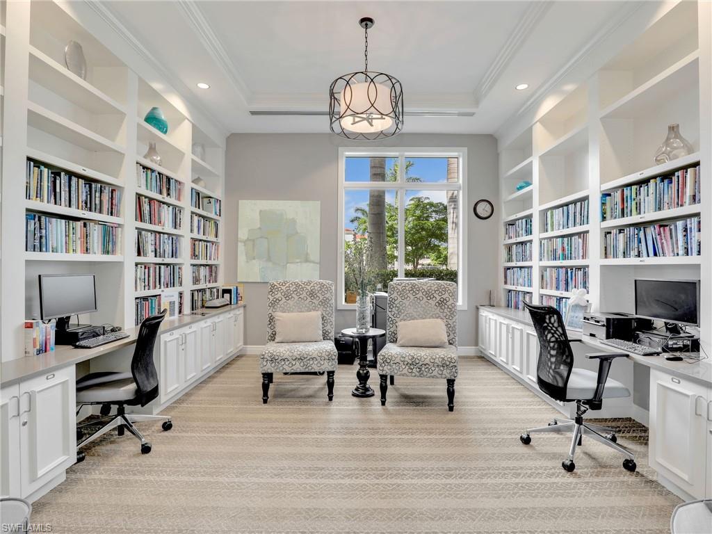 20064 Wymberly Way Estero, FL 33928 - Photo 43 of 47 a living room with furniture a rug a chandelier and a book shelf