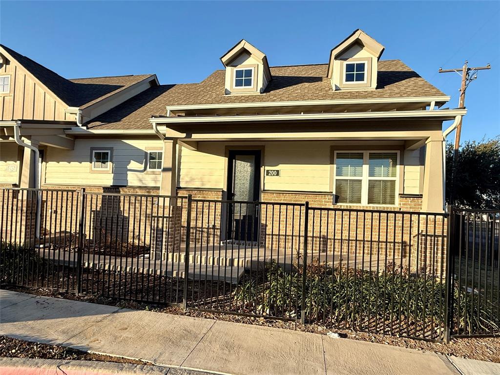 a front view of a house with a iron stairs