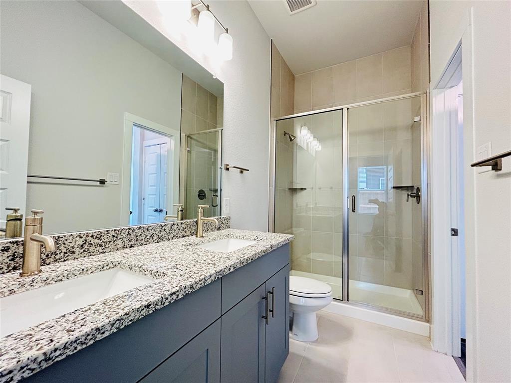 760 West Bedford Euless Road, Unit 200 Hurst, TX 76053 - Photo 14 of 39 a bathroom with a granite countertop sink toilet and shower