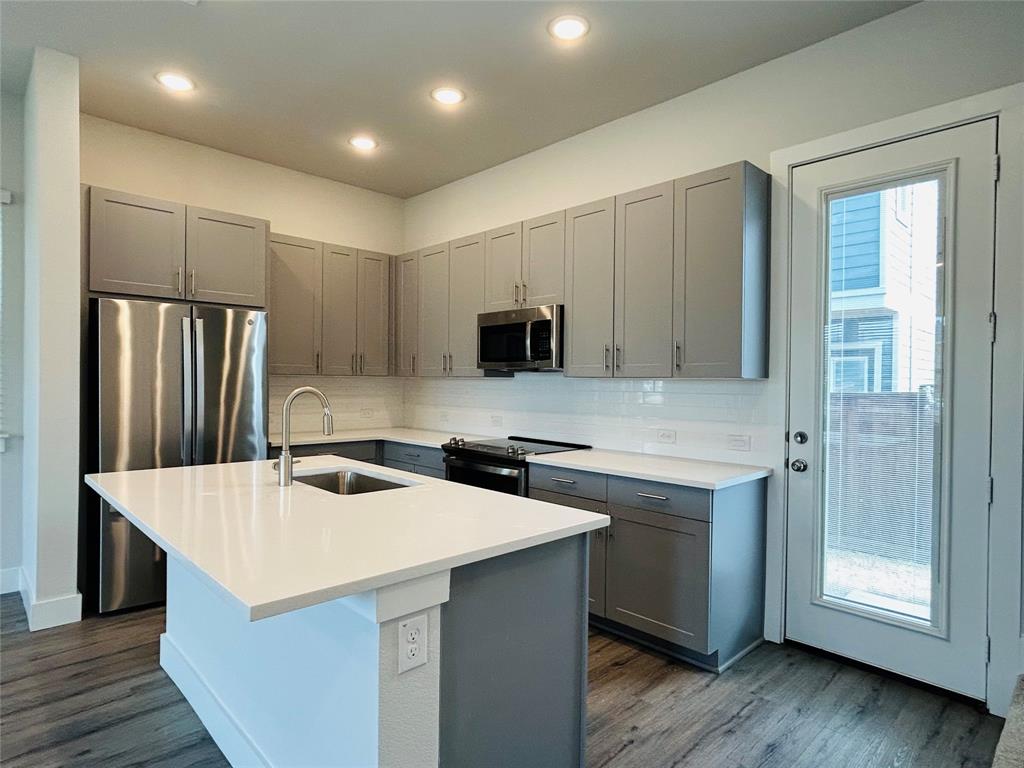 760 West Bedford Euless Road, Unit 200 Hurst, TX 76053 - Photo 18 of 39 a kitchen with stainless steel appliances a microwave a sink and refrigerator