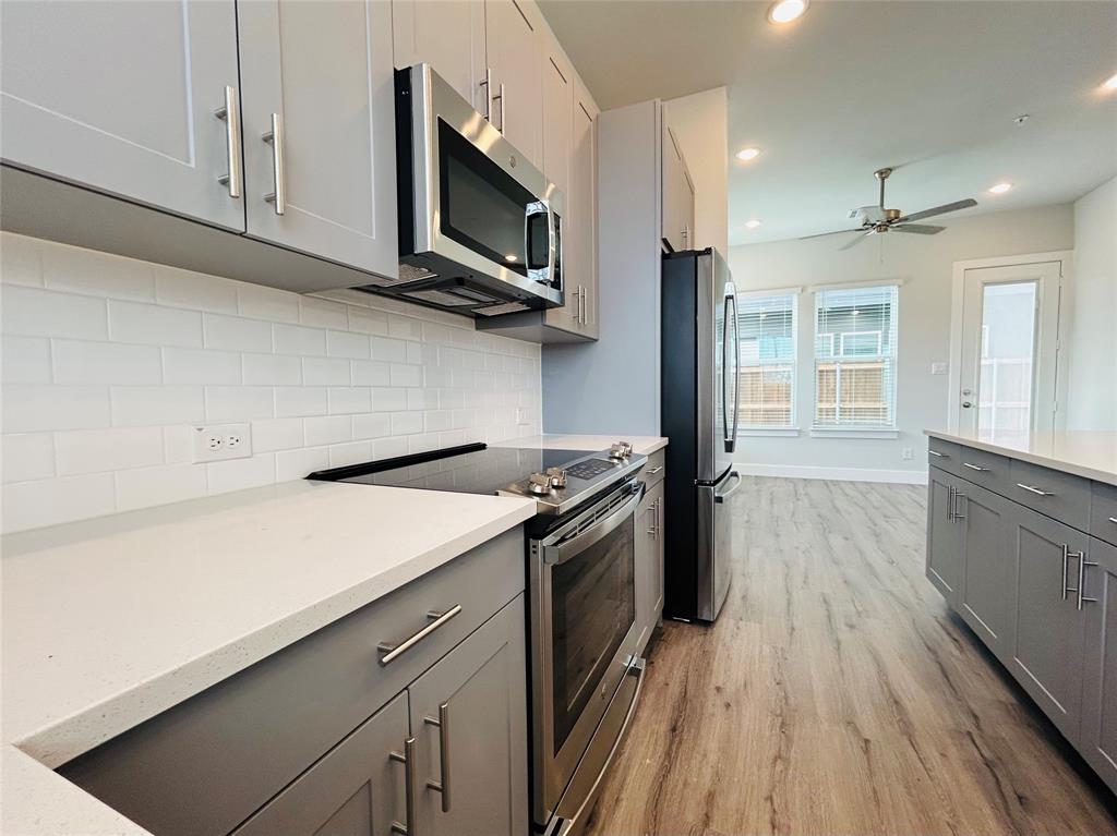 760 West Bedford Euless Road, Unit 200 Hurst, TX 76053 - Photo 21 of 39 a kitchen with stainless steel appliances a stove microwave and refrigerator