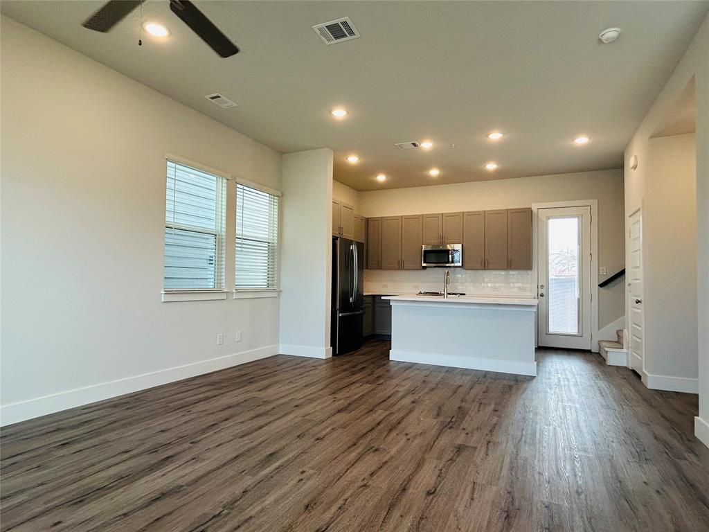 760 West Bedford Euless Road, Unit 200 Hurst, TX 76053 - Photo 23 of 39 a large kitchen with a center island wooden floor and stainless steel appliances