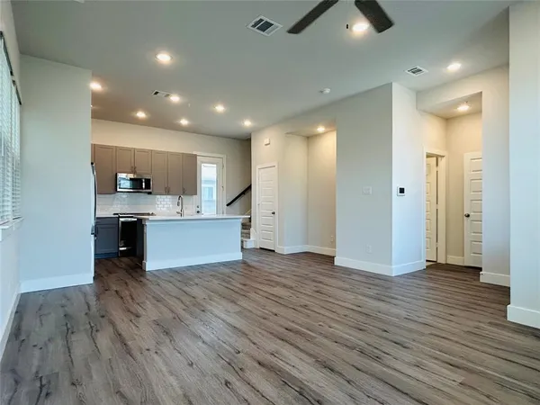 a bathroom with a granite countertop sink a toilet and shower