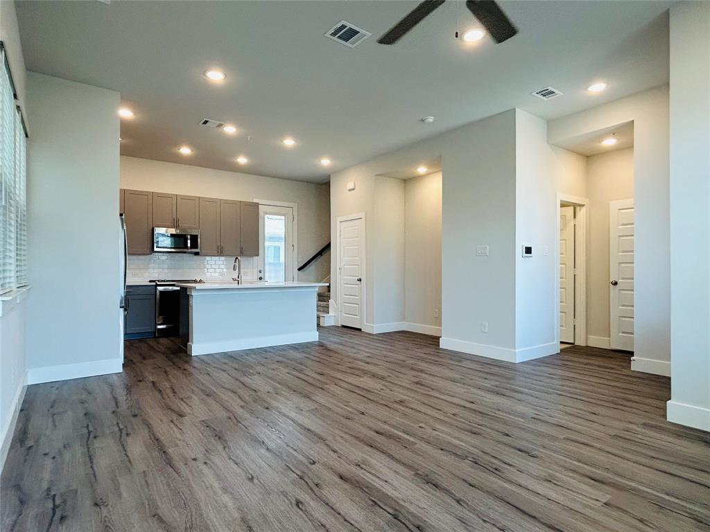 760 West Bedford Euless Road, Unit 200 Hurst, TX 76053 - Photo 25 of 39 an open kitchen view with wooden floor and a window