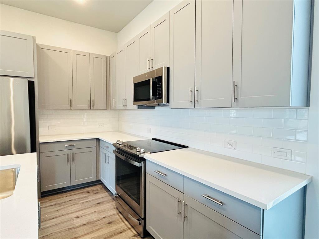 760 West Bedford Euless Road, Unit 200 Hurst, TX 76053 - Photo 26 of 39 a kitchen with a sink stove and cabinets