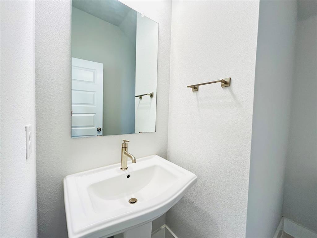 760 West Bedford Euless Road, Unit 200 Hurst, TX 76053 - Photo 35 of 39 a bathroom with a sink and a mirror