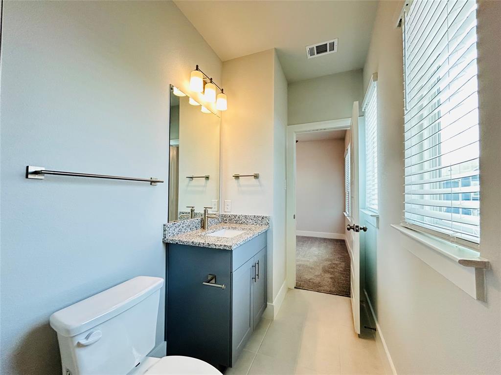 760 West Bedford Euless Road, Unit 200 Hurst, TX 76053 - Photo 37 of 39 a bathroom with a granite countertop sink toilet and shower