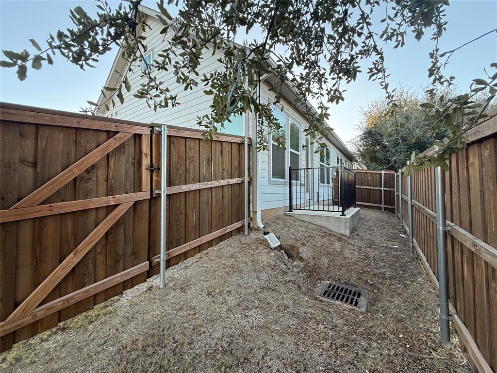 760 West Bedford Euless Road, Unit 200 Hurst, TX 76053 - Photo 5 of 39 a view of backyard with wooden fence and large trees