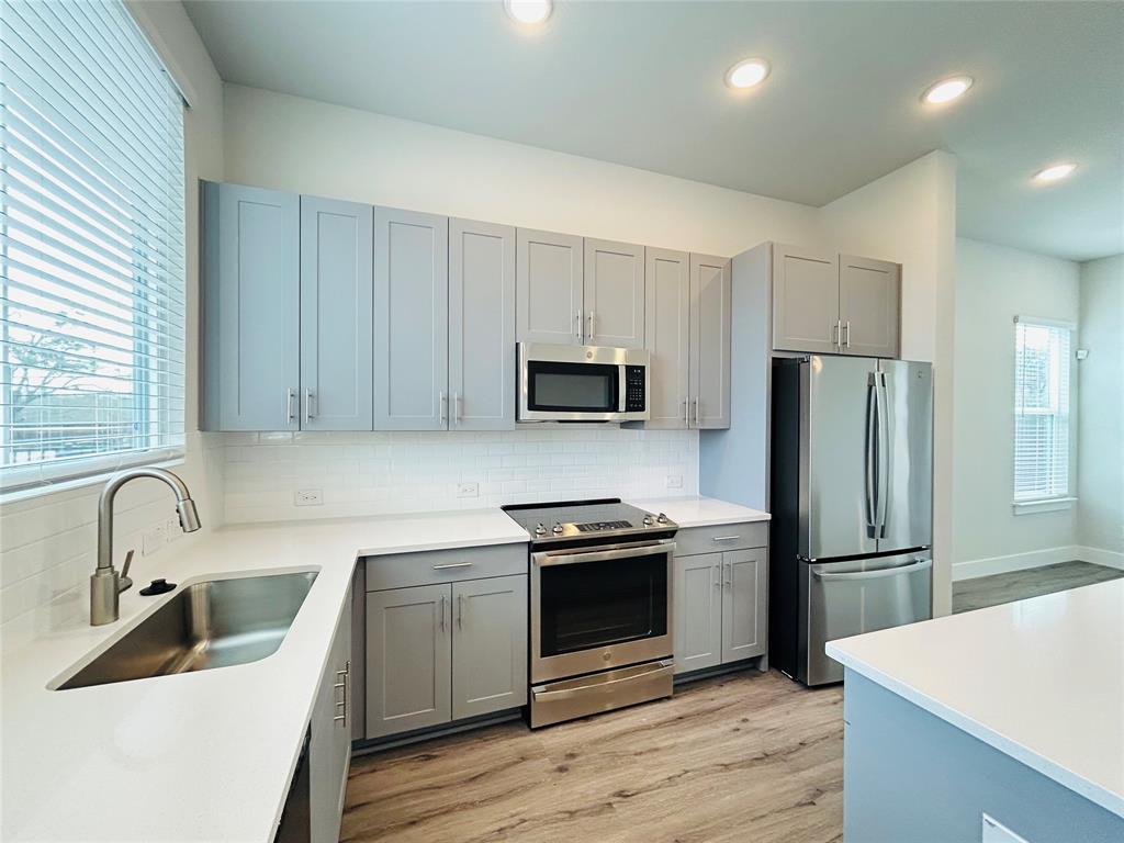 760 West Bedford Euless Road, Unit 200 Hurst, TX 76053 - Photo 10 of 39 a kitchen with wooden cabinets and stainless steel appliances