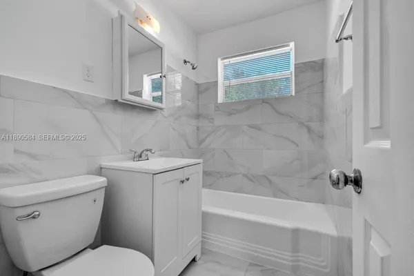a bathroom with a sink toilet and bathtub