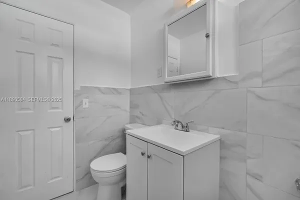 a bathroom with a sink toilet and vanity