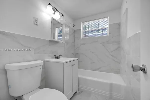a bathroom with a sink toilet and bathtub