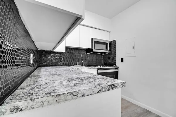 a kitchen with kitchen island sink and stove