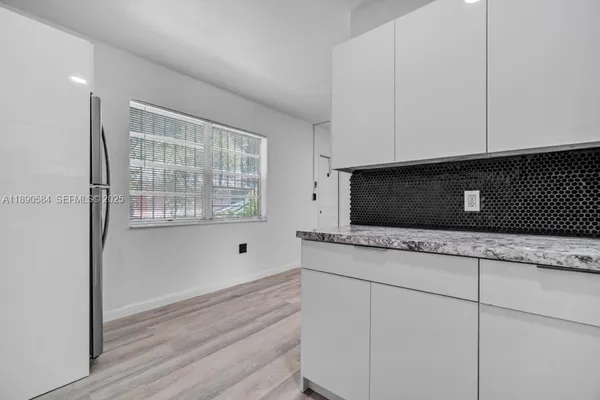 a kitchen with stainless steel appliances granite countertop cabinets and wooden floor