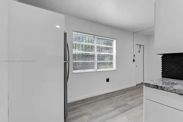 a view of kitchen with wooden floor