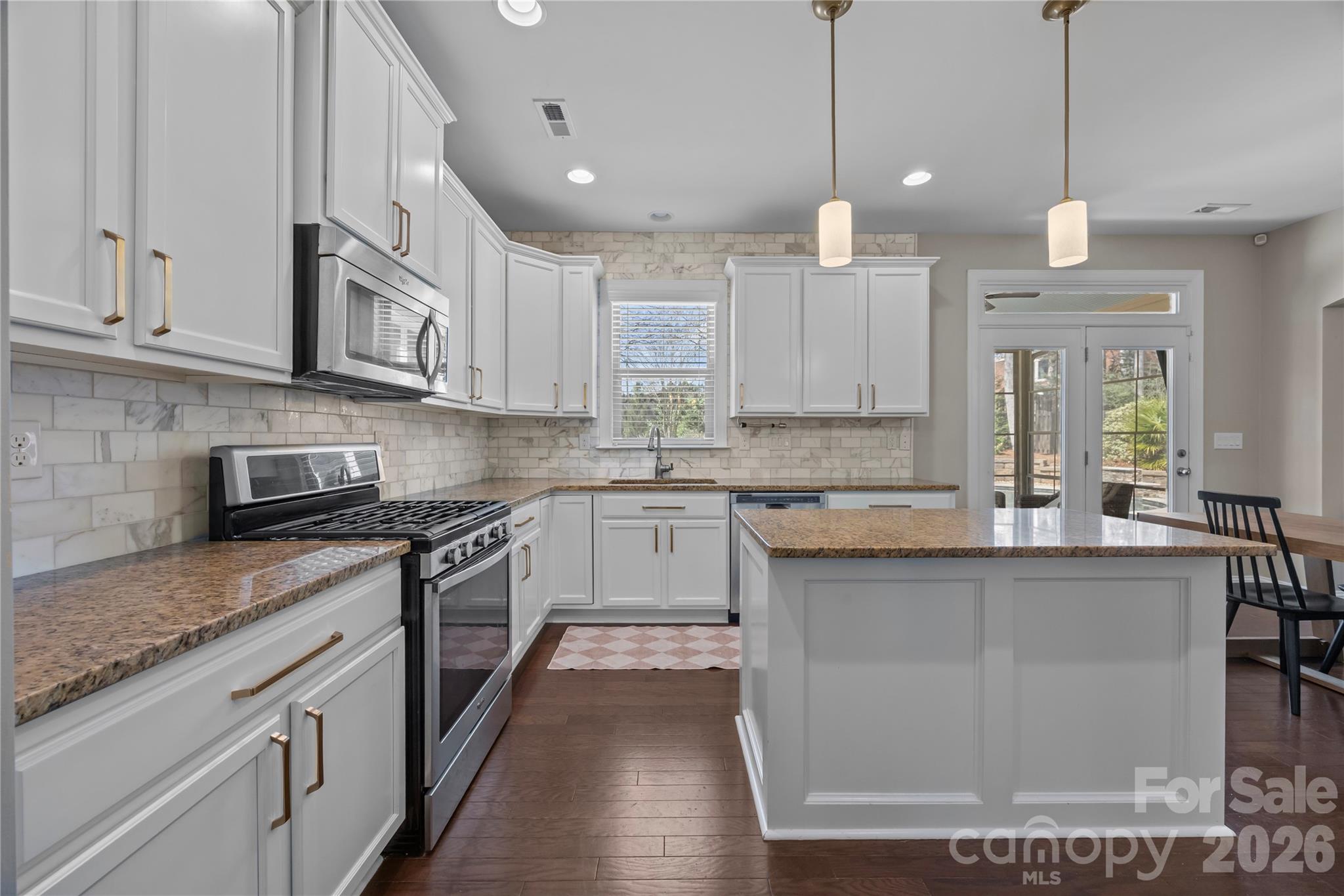 921 Rock Forest Way Fort Mill, SC 29707 - Photo 11 of 40 a kitchen with kitchen island granite countertop a sink a counter space appliances and cabinets