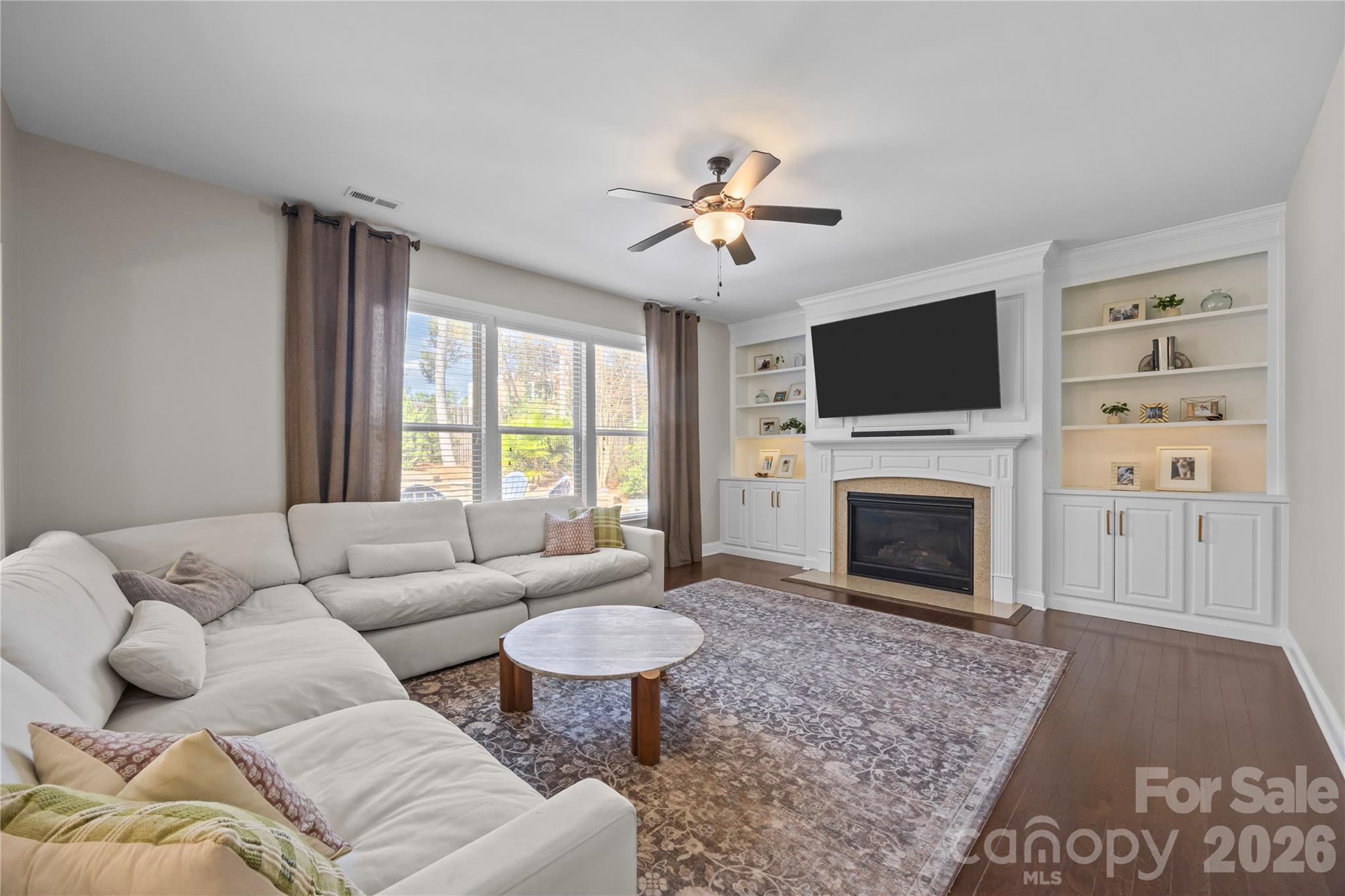 921 Rock Forest Way Fort Mill, SC 29707 - Photo 16 of 40 a living room with furniture a fireplace and a flat screen tv