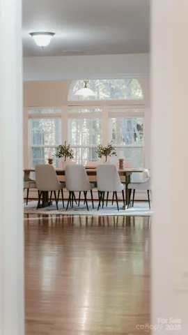 a view of an empty room with chandelier and a window