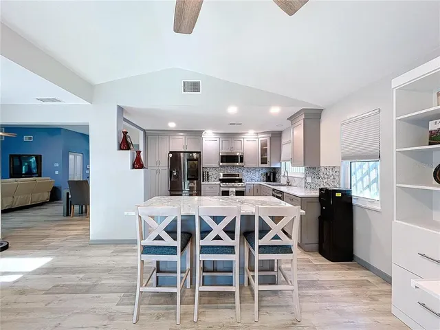a bedroom with a large bed and a flat tv screen on dresser
