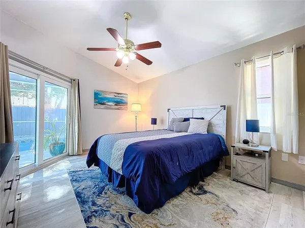 a bedroom with a large bed and a large window