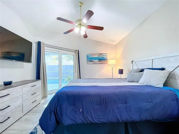 a large bed sitting in a bedroom next to a window
