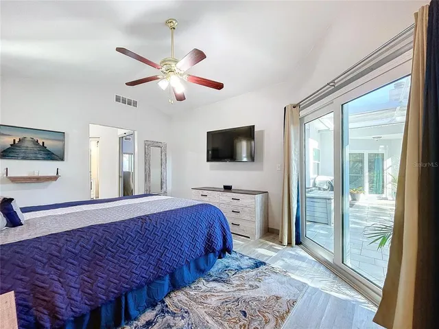 a large bed sitting in a bedroom next to a window