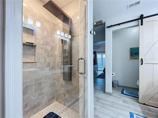 a bedroom with a bed and a large mirror