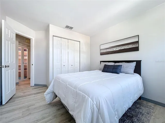 a view of a patio with table and chairs a barbeque with potted plants and floor to ceiling window